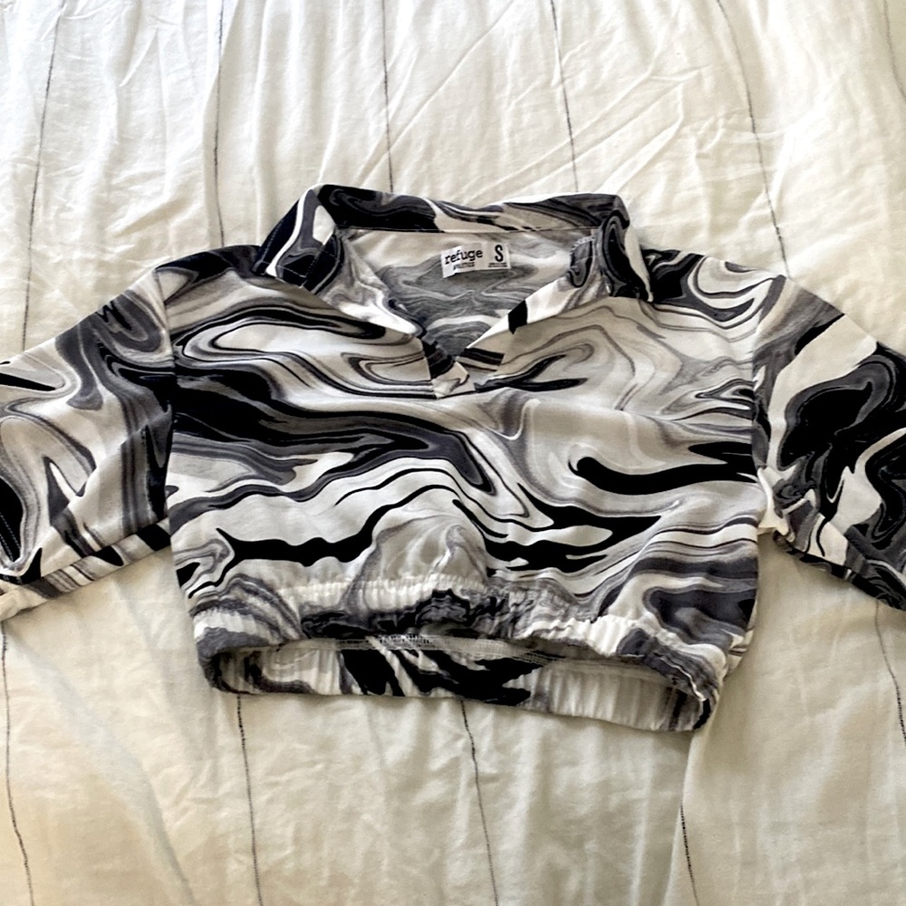 This is a cropped black and white shirt.